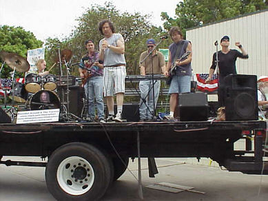 The Traitors play live on a flatbed truck, through a solar powered PA, in an anti-fraudulent energy crisis, anti-Bush demonstration, Long Beach CA, July 4, 2001 - CLICK FOR NEXT IMAGE
